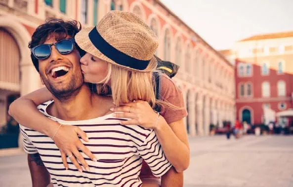 Couple laughing in a European square