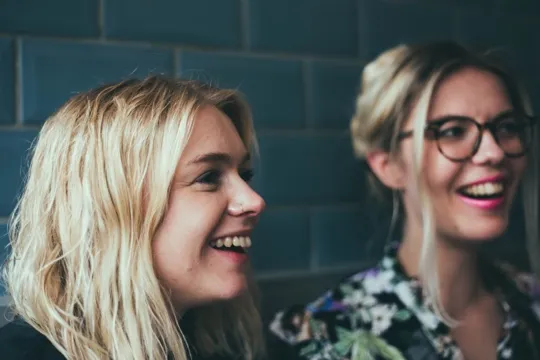Two women laughing together