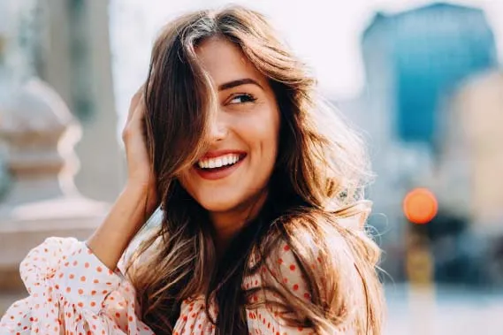 Woman smiling with hair in the wind